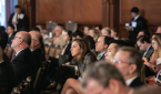 Audience members watch a presentation at the Triological Society Combined Sections Meeting.
