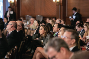 Audience members watch a presentation at the Triological Society Combined Sections Meeting.
