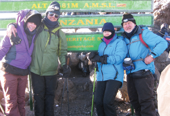 Dr. Woodson and her husband, Tom Robbins, on the right and their daughter Sarah and son Nick on left, on Mount Kilimanjaro.