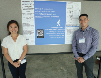 Medical students Jennifer Li and Vincent Bo with their minimalist poster at the Midwest Regional Pain Interest Group Meeting in Kansas City, Kansas. Interested viewers can scan a QR code with their smart device to get more information about a poster or its authors. Credit: Jennifer Villwock, MD