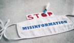 A medical mask with the word "misinformation" written across it