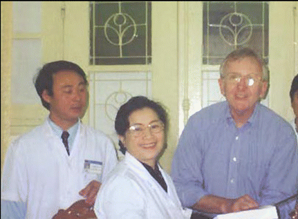Figure. The visiting otolaryngologists have helped to provide the Vietnam hospitals with teaching materials, like the book Dr. Bailey is holding.
