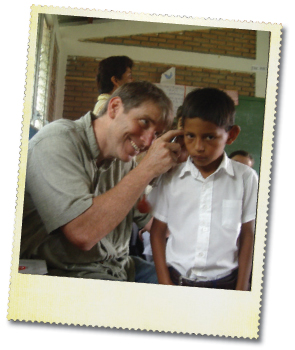 Dr. Saunders conducting a screening for ear pathology and hearing loss among children in second grade in Nicaragua