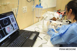 A resident uses a temporal bone surgery simulator to perform a mastoidectomy, complete with image guidance feedback for anatomy.