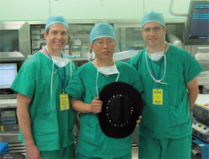 Dr. Andrew L. de Jong, left, and Dr. Ron Kuppersmith, right, of Texas ENT and Allergy in College Station, Tex, traveled to Seoul, South Korea, to observe the robotic thyroid surgery pioneered by Dr. Woong Youn Chung, center, of Yonsei University College of Medicine, who is holding the cowboy hat presented to him by the visiting surgeons