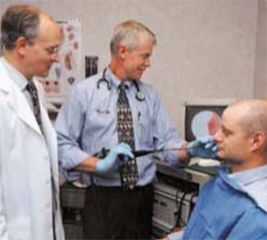 Drs. Smith (right) and Elstad (left) perform a flexible bronchoscopy on a patient who is unsedated