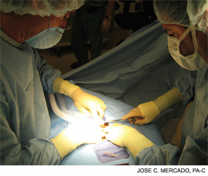 Scott H. Goldberg, MD, (right) and Jose C. Mercado, PA-C, (left) perform a tracheostomy