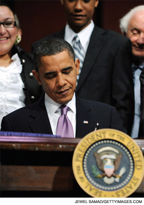 President Obama signing the health reform bill